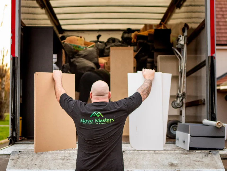 A Move Masters mover carrying a protected item towards a removal vehicle