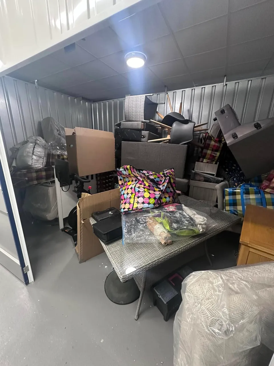 Furniture and household belongings inside a storage container